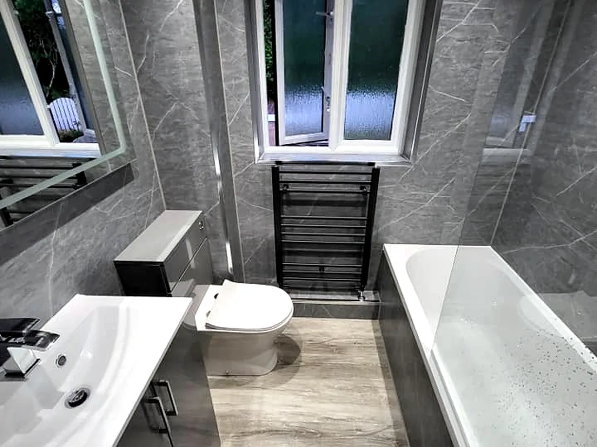 Bathroom after renovation, marble tile and black fittings