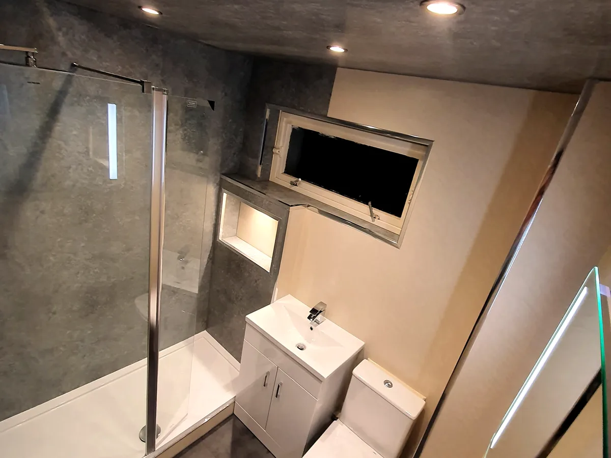 Family bathroom after renovation with walk-in shower